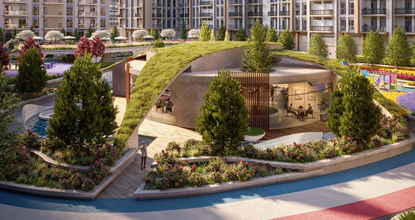 Landscaped courtyard with a planted mound, shaded pavilion, water and winding paths between residential blocks