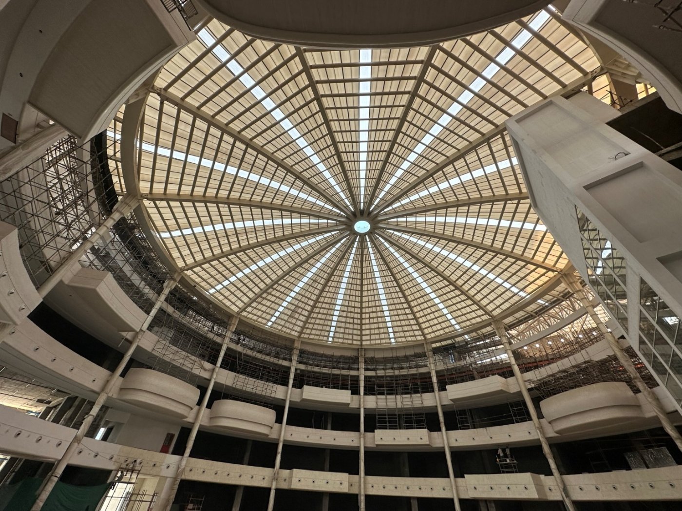 Fifty-five metres, six of rise. The Gurugram dome, with a plaza roof alongside whose trusses cross at the centre for lateral stability.