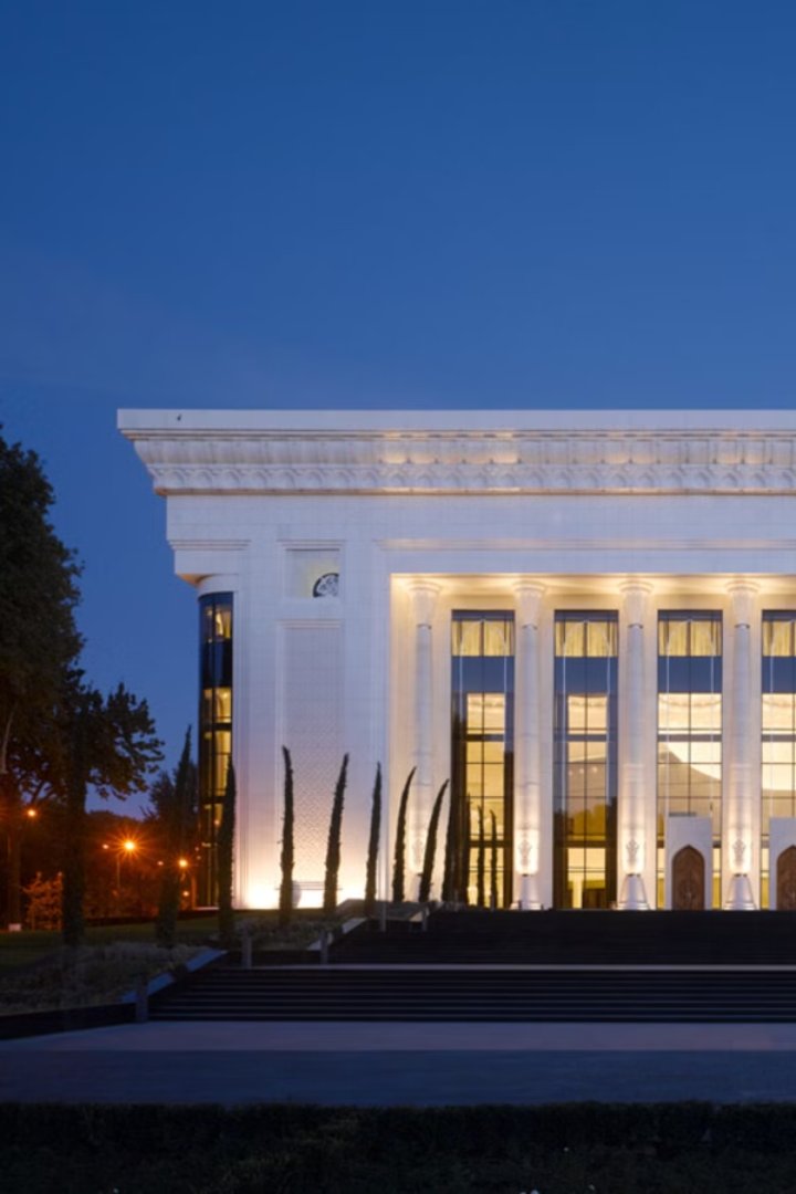 A colonnaded concert hall lit at dusk