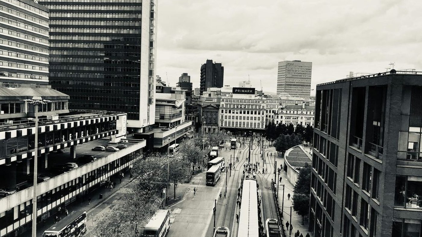 A historic Manchester street in black and white