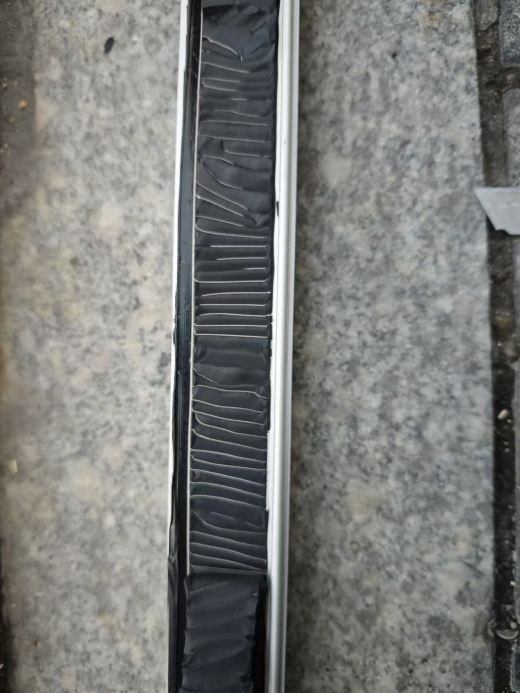 Cut out and pulled. The joint tested in place rather than a fresh specimen, which is where the elasticity claim comes from.