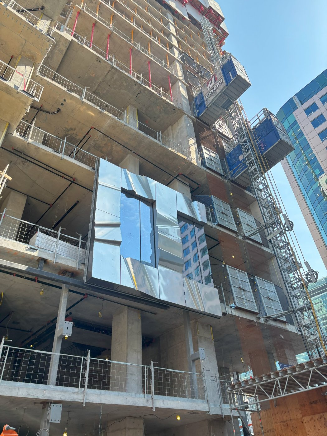 Going up. A stainless steel rainscreen over a highly repeatable curtain wall system, which is where all the movement and performance is handled.