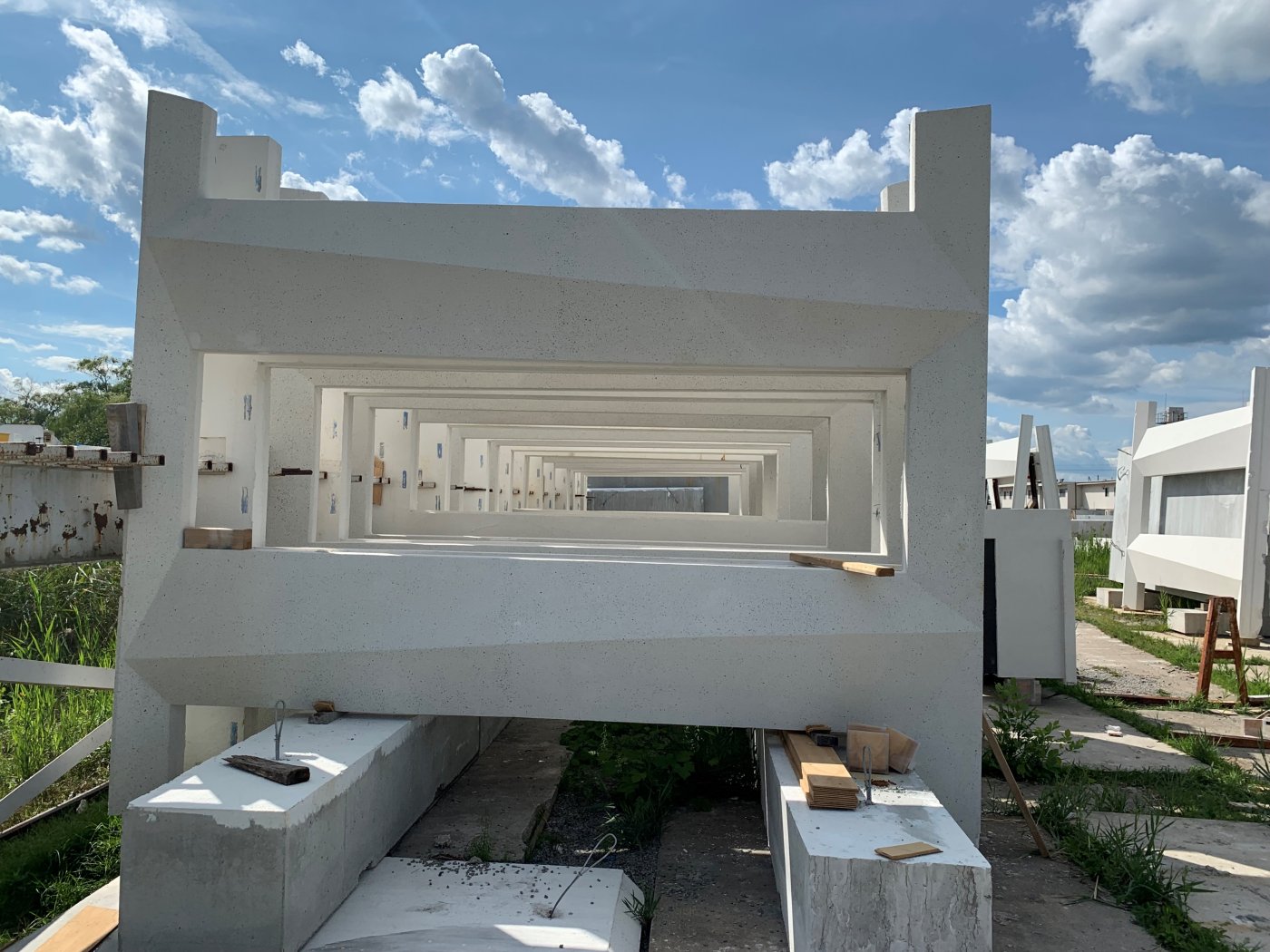 Every window the same size. The precast takes up the difference as the form tapers, which is what makes one window size possible across a leaning building.