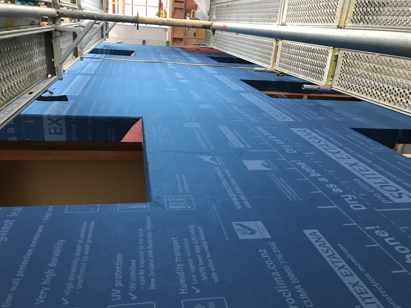 What is on the inside. The membrane taped across the test wall before any cladding goes on: the layer that makes the assembly weathertight, and the one nobody sees again.