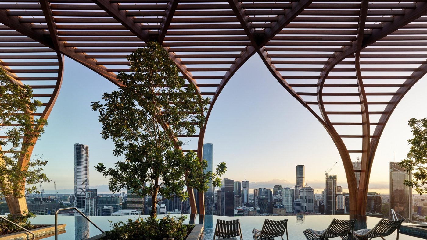 Rooftop timber canopy of curved glulam over communal space