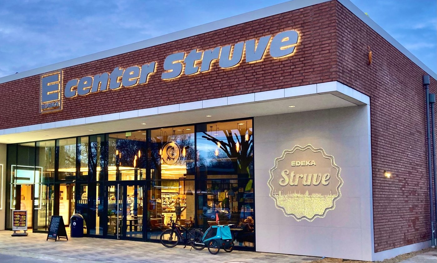 Edeka storefront with illuminated concrete logo