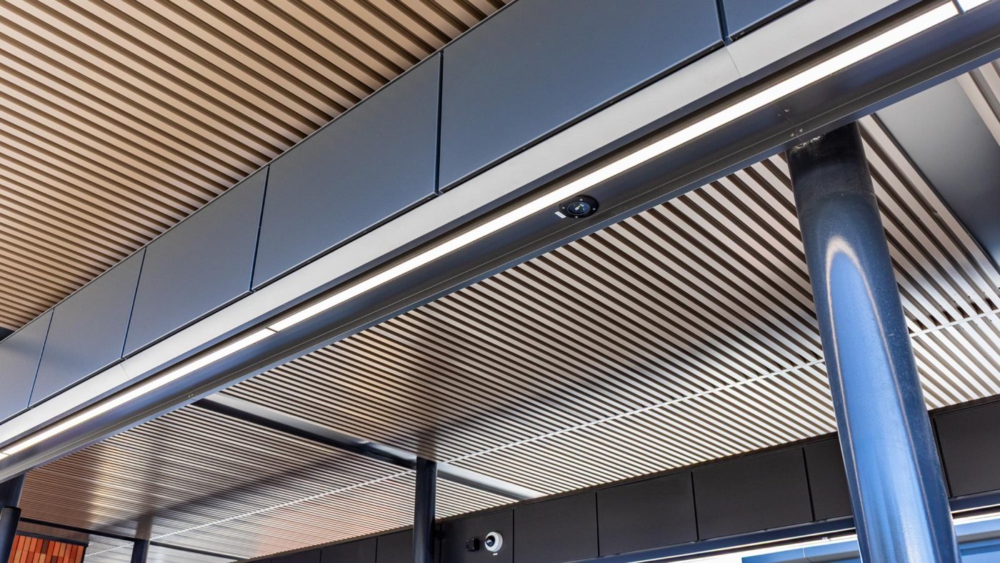 Metal soffit with lighting integrated into the panel system