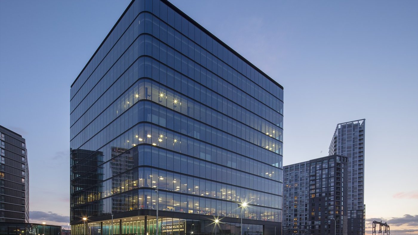 Modern glass office building at dusk
