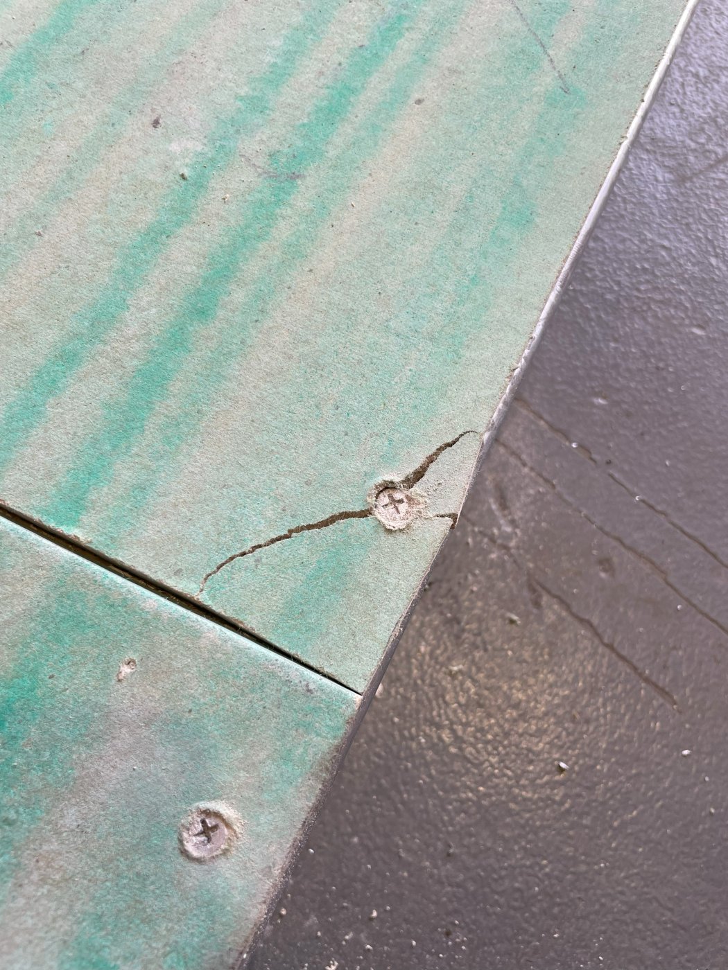 Boards crack. On installation from an overdriven screw, and under wind load as hairline fractures, and a hairline crack is a pathway. Hence the fully adhered membrane over the top.