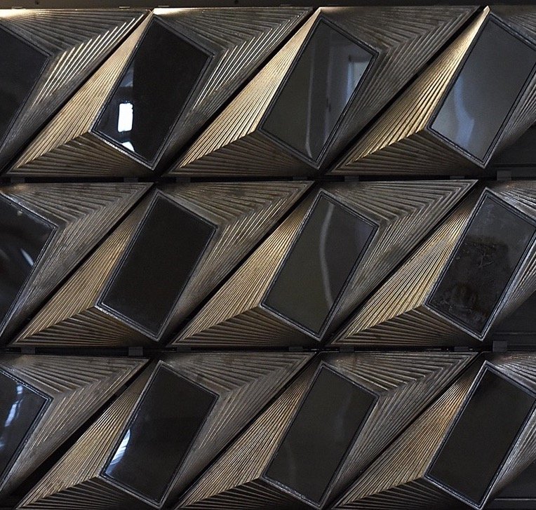 Terracotta holding photovoltaics. Woods Bagot asked whether the two could make one integrated façade, with the panels angling the cells to capture the most possible solar energy.