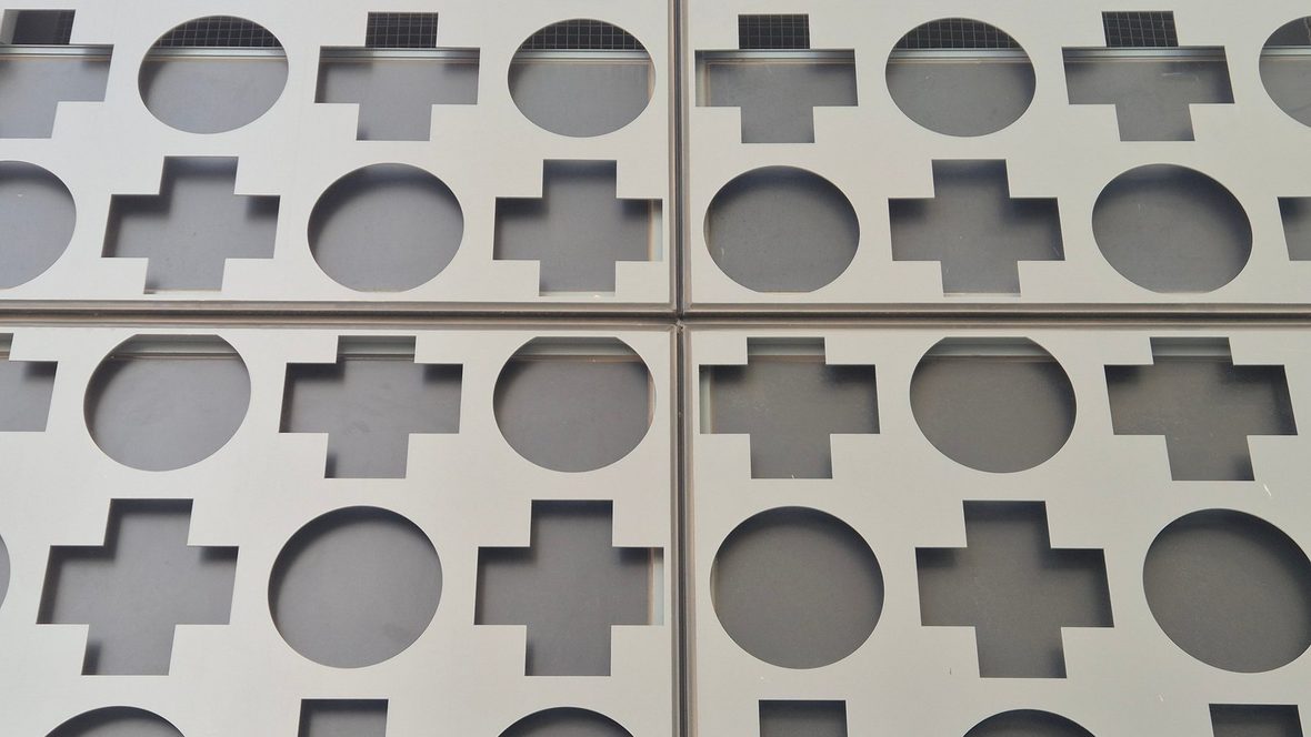 Perforated aluminium screen forming the Alfred hospital’s circle-and-cross logo