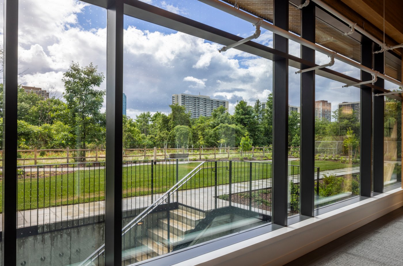 Above the Don Valley. Expansive glazing brings the ravine inward rather than framing it as a picture.