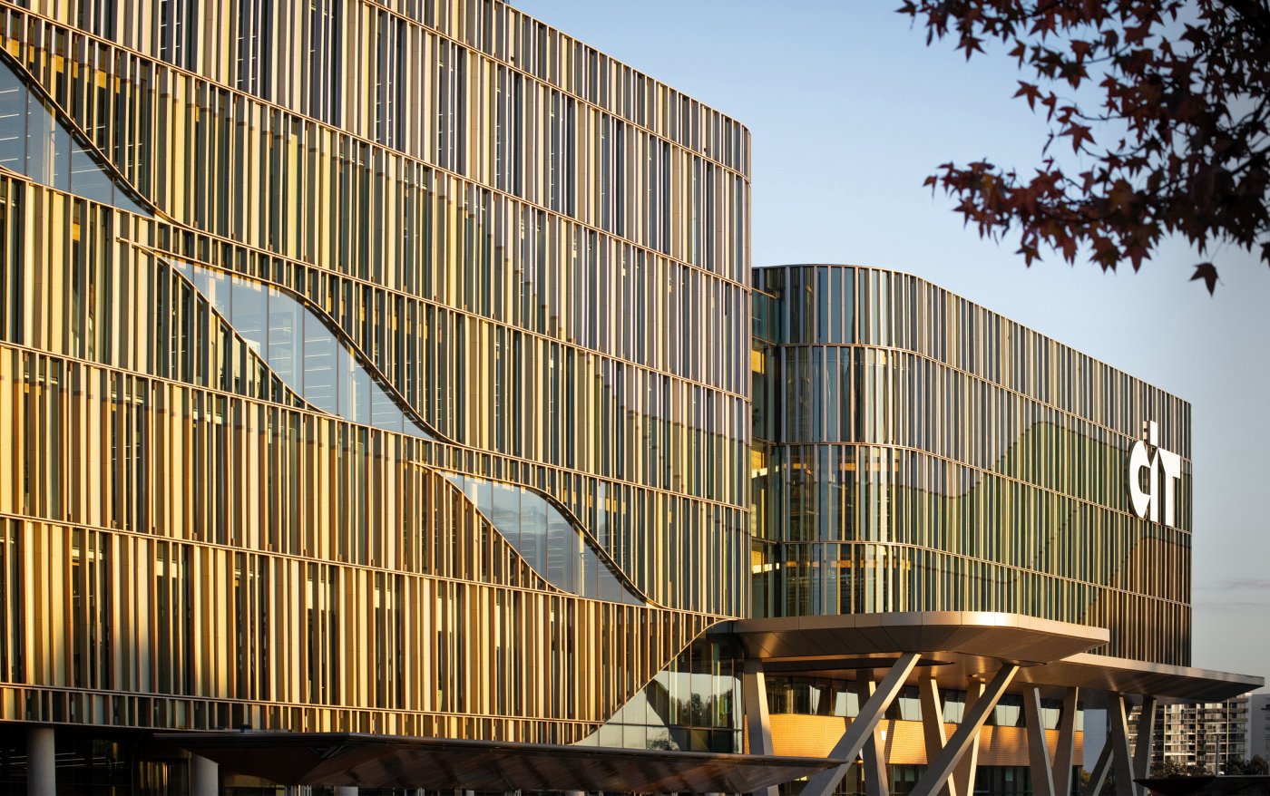 Canberra Institute of Technology, Woden. Four bands of terracotta battens in varying depths and tones, hung in front of a hit-and-miss curtain wall so the colour blends as you move.