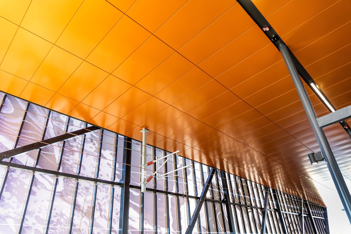Perforated steel undercroft ceiling with integrated lighting