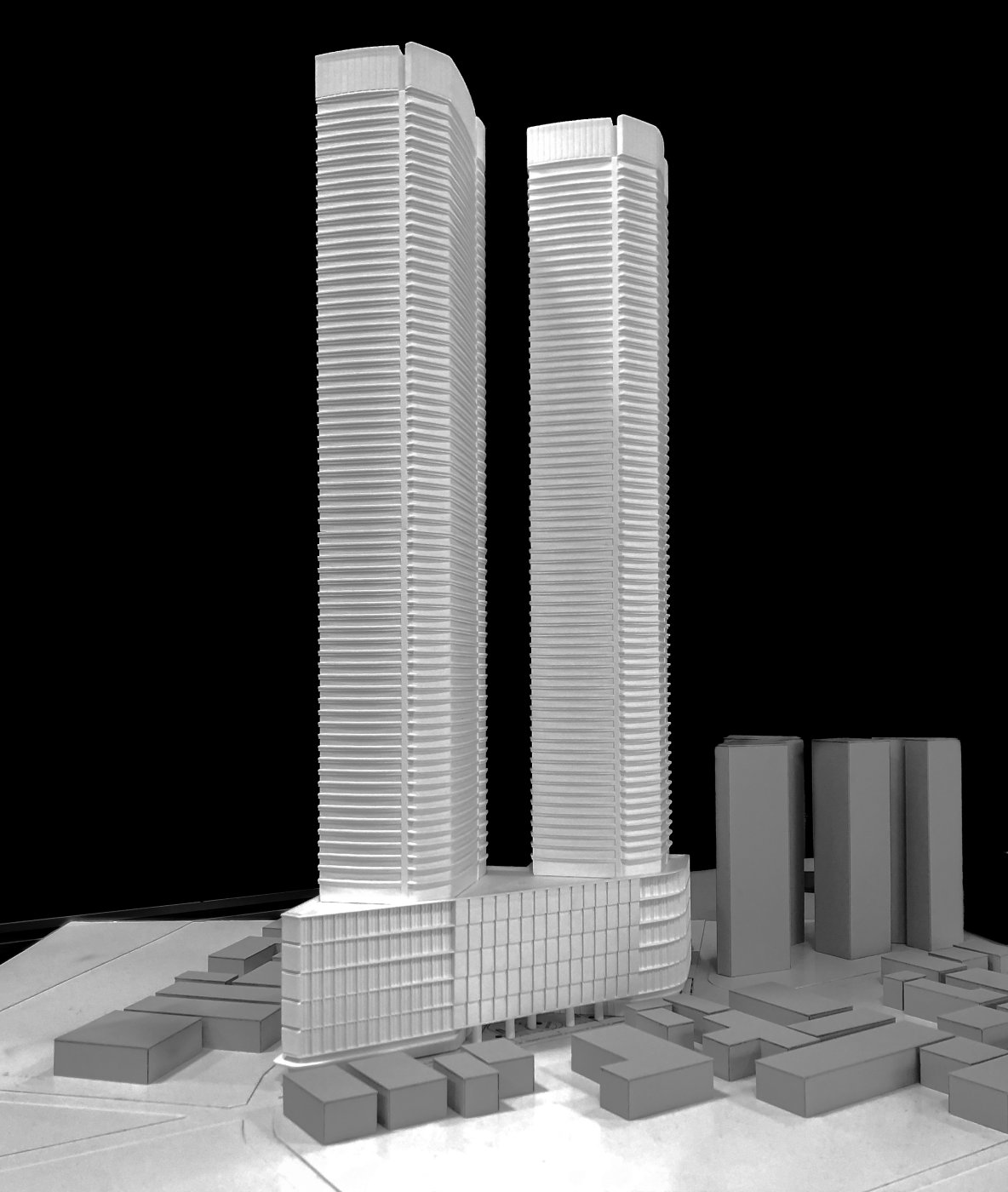 Two towers, one process. Phasing a development into tower one and tower two spreads the design work out, which is what lets the later half learn from the earlier half.