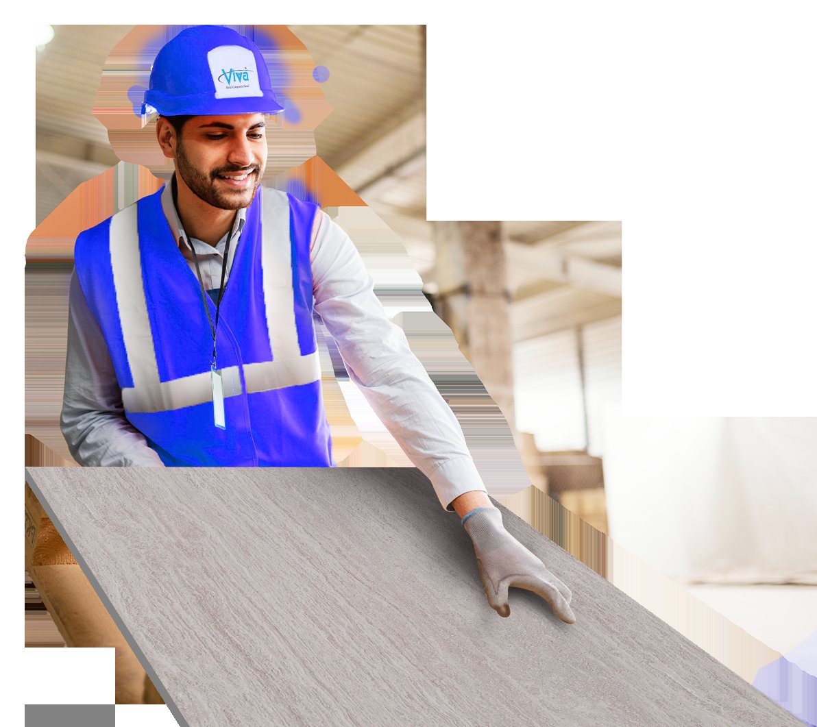 A worker handling a large metal cladding panel in a workshop