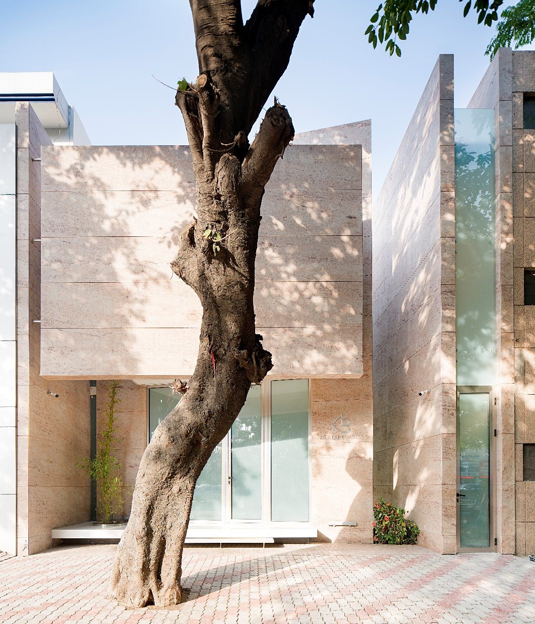 A very short frontage. The elevation is the form itself, arrived at in plan, with no layer applied over it.
